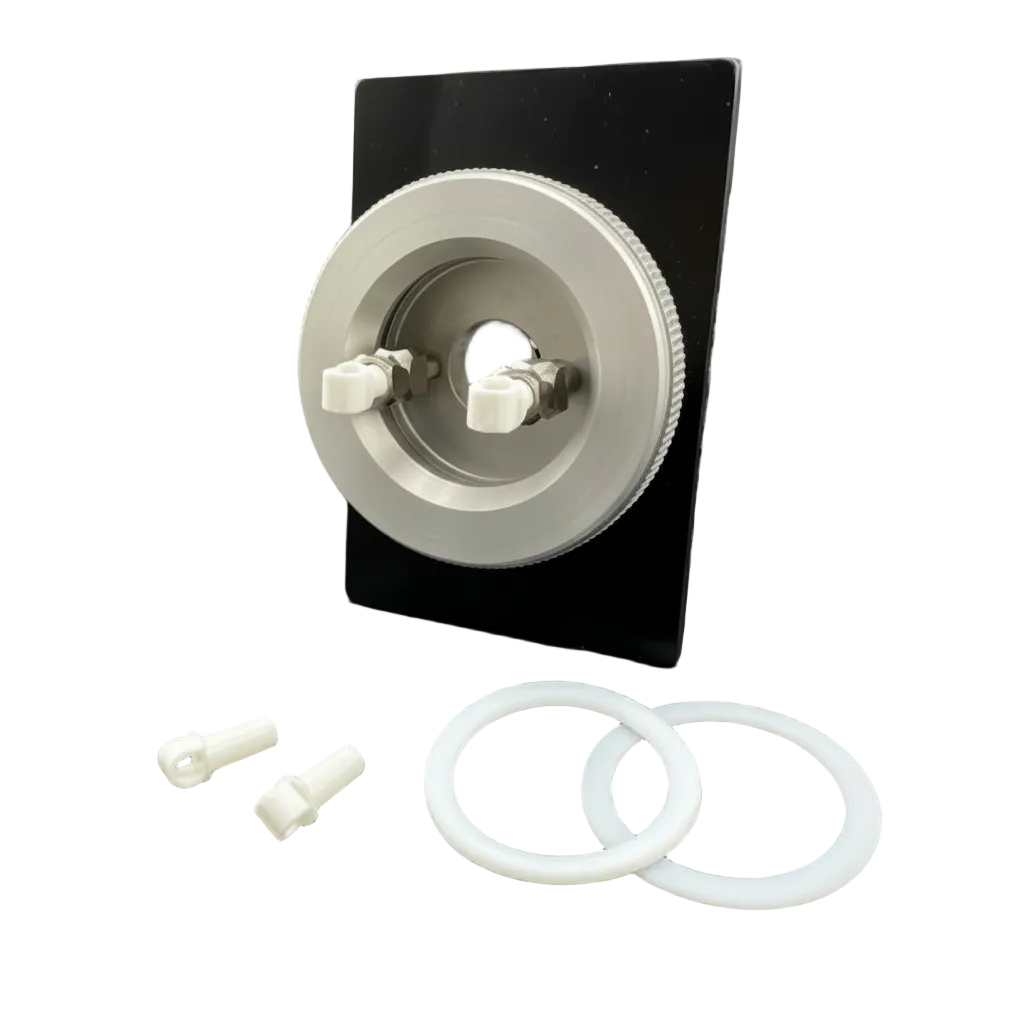 A silver metal circular component with two white plastic connectors, displayed on a black backing plate with two white O-rings and two small white plastic pieces on a dark gray background.
