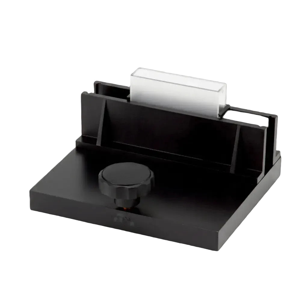 Black desk organizer with a small round item on a white background