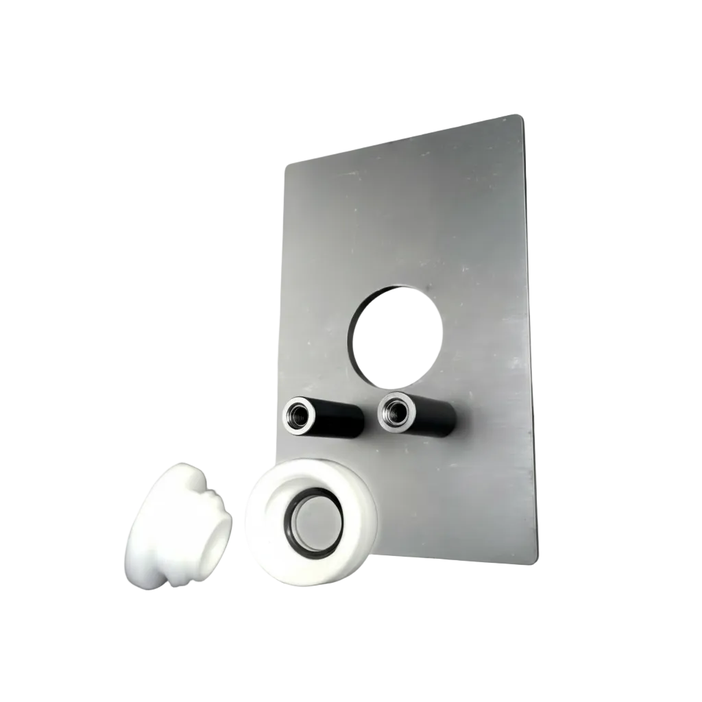 A brushed metal mounting plate with a circular cutout and two black cylindrical inserts, shown with two white cylindrical components on a light gray studio background.