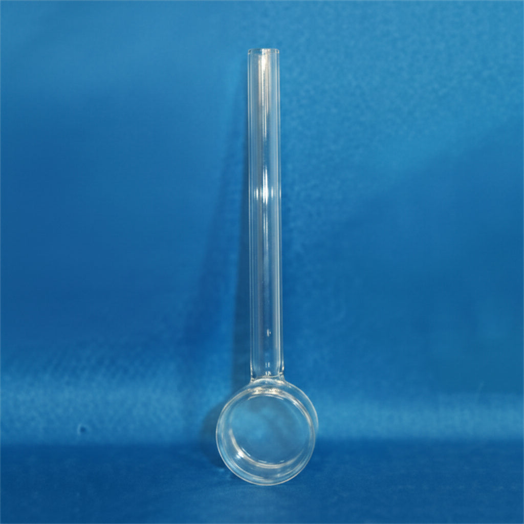 A clear glass stirring rod with a long, straight stem and a circular bowl at the bottom, standing upright against a textured blue background.